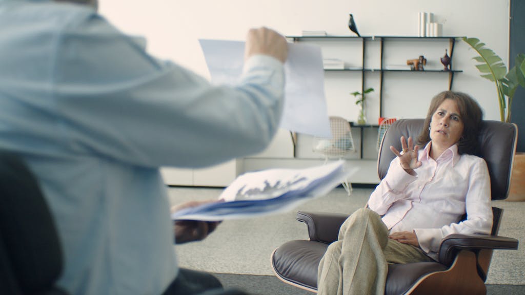 A therapist conducts a session in a contemporary office, offering mental health support.